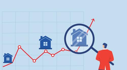 Person holding magnifying glass up to line graph with houses