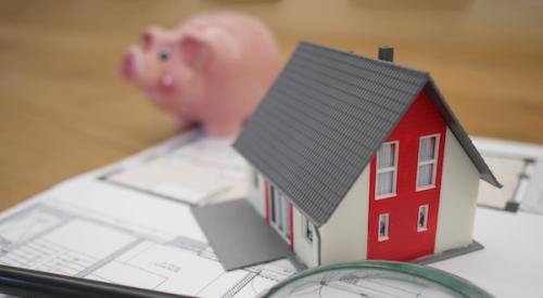 Magnifying glass with a model of a house