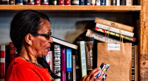 Woman using mobile device in a bookstore