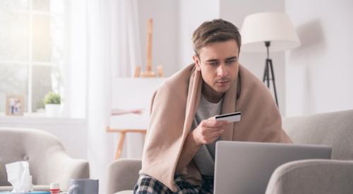 man looking at credit card