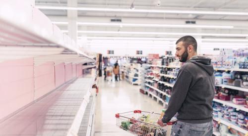 Man looking at empty shelf