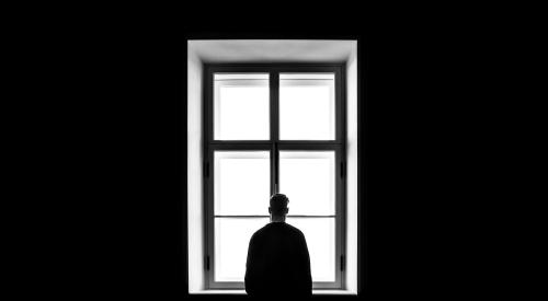 man facing window