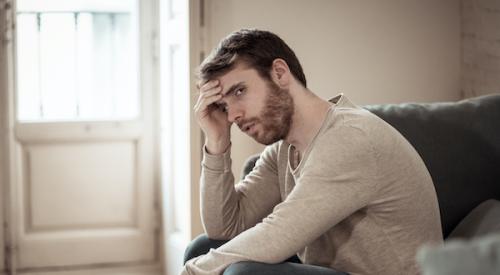 Man upset sitting at home