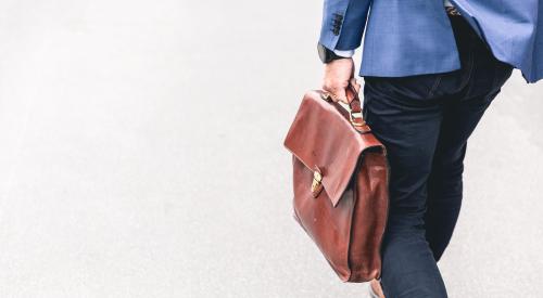 Businessman with briefcase walking