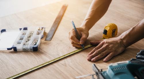 Using tape measure to mark up plywood before making cuts