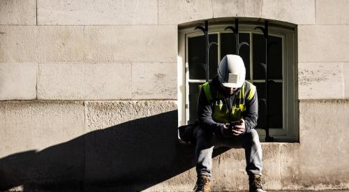 Construction worker looking at phone on break