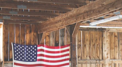 US Flag hanging inside of wooden structure