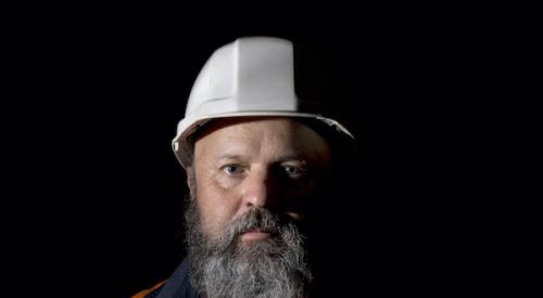 bearded middle-aged construction worker wearing hard hat