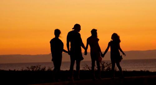 Family walking in the sunset