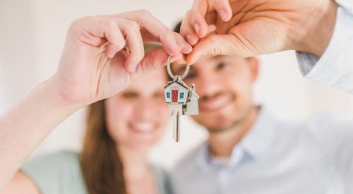 Millennial homebuyers with house keys in hand