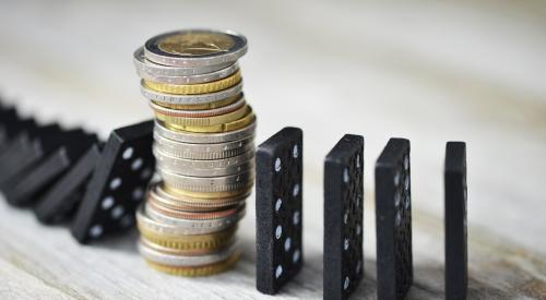 Stack of coins in between falling dominoes 