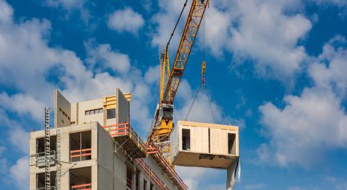 Modular units being installed by crane on a multifamily project 