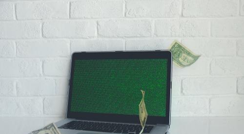 Laptop computer with dollar bills