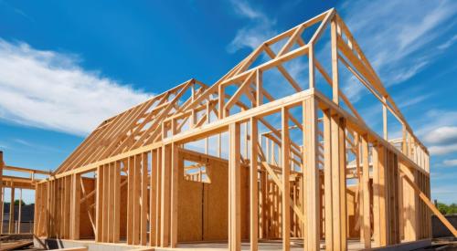 Wood-framed house under construction on a sunny day