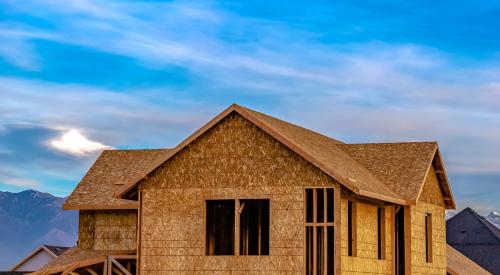 New house under construction against blue sky