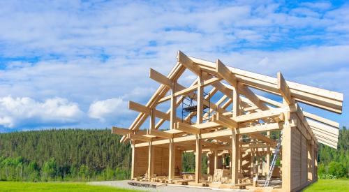 New home framed under construction in countryside