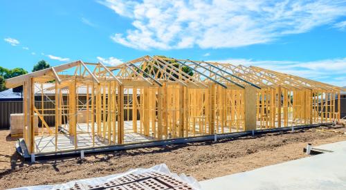 Newly framed home with blue sky in background