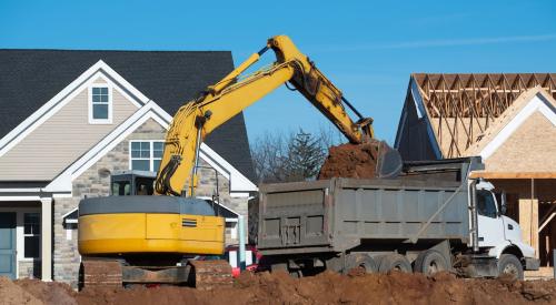 Crane in front of two new houses in development