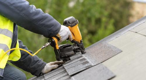 New asphalt shingles being installed on roof