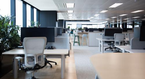 Empty office space with desks and chairs