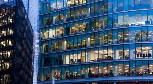 Exterior of commercial office building with windows lit up