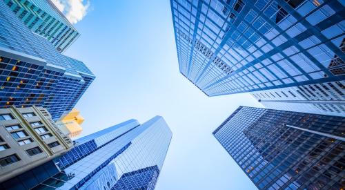 Exterior of office buildings in city looking up to sky