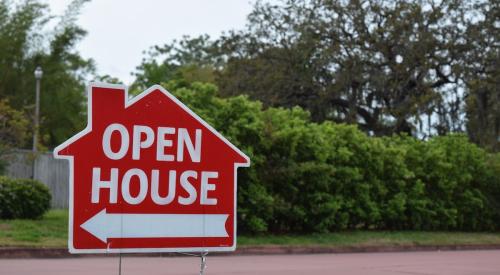 Red open house sign on lawn