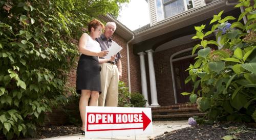 Red and navy blue open house sign with arrow on residential lawn