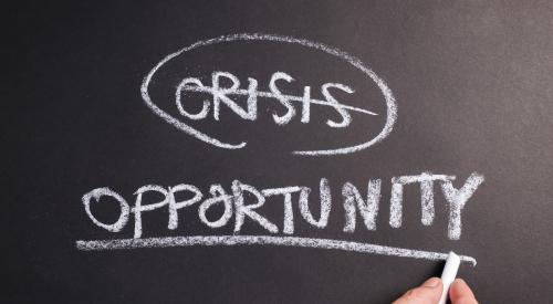 Chalk board with crisis and opportunity written on it