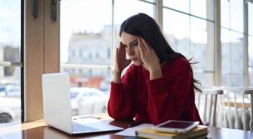 Overwhelmed woman looking at homes