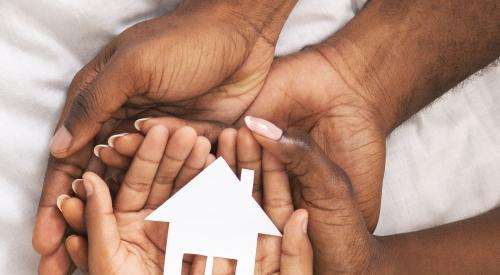 Hands holding a house cutout