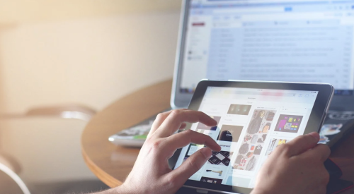 Person using tablet and laptop