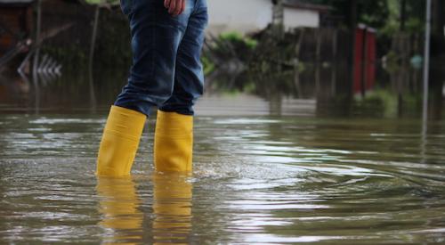 Person wading through floodwaters