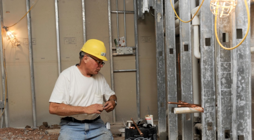 Plumbing tradesman working on construction site at the framing stage