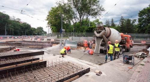 Construction workers pouring concrete on jobsite