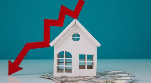 Small house on top of stack of cash next to red declining arrow