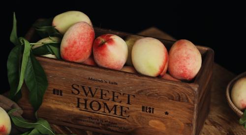 Box of peaches on a table