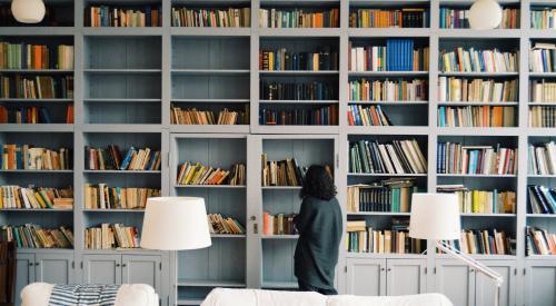 Woman at built-in bookcase