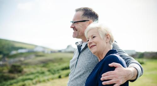 Senior couple in green field