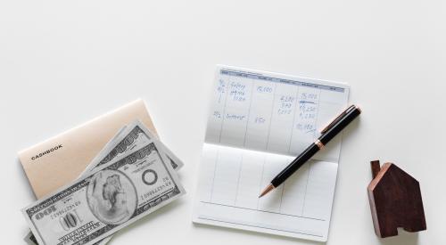 Table with checkbook, cash, pen