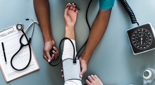 Nurse taking blood pressure reading