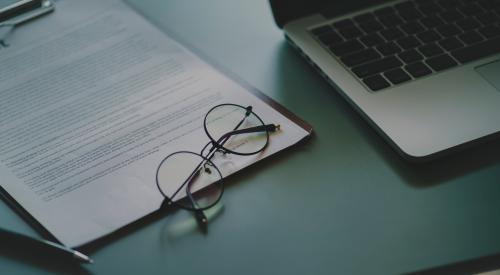 Laptop, application, eyeglasses on desk