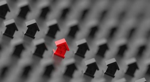 Red house model surrounded by small black houses