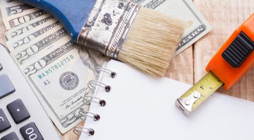 Home renovation supplies on table next to calculator and money