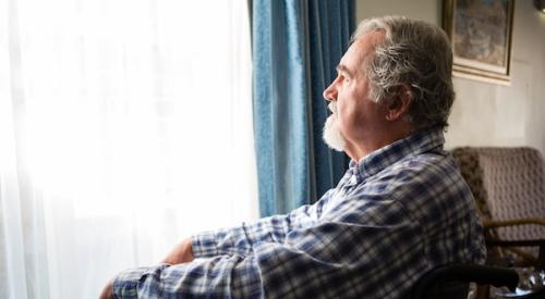 Retired man looking at window