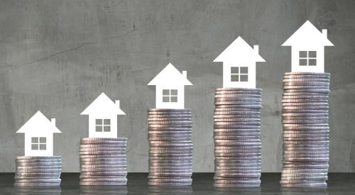 White homes on stacks of coins growing in size