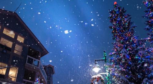 Building exterior at night with snow and Christmas decorations