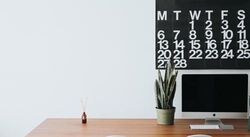 Desk with chair and calendar and computer