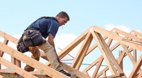 Builder working on roof frame