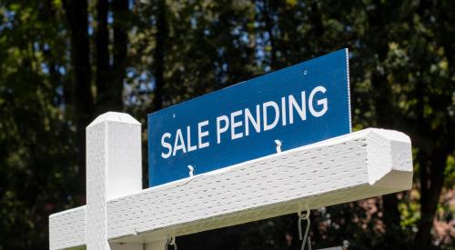 Blue sale pending sign above white for sale sign